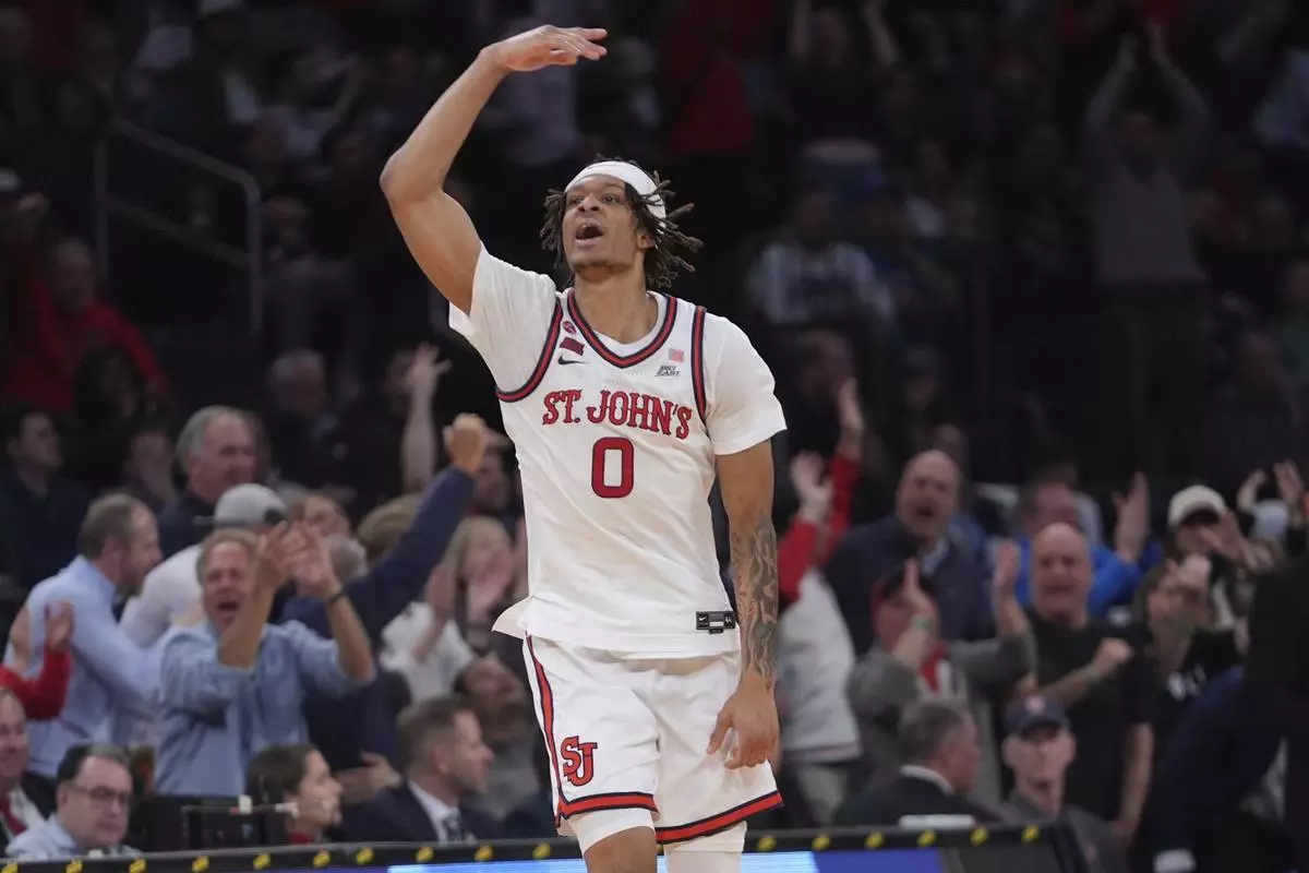 St. John's's Aaron Scott (0) celebrates after making a three-point shot during the second half of an NCAA college basketball game against the Marquette in the semifinals of the Big East tournament Friday, March 14, 2025, in New York. (AP Photo/Frank Franklin II)