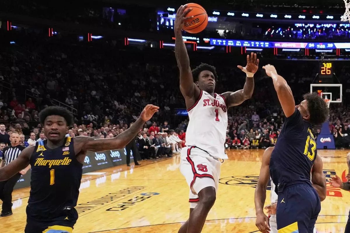 St. John's's Kadary Richmond (1) shoots over Marquette's Royce Parham (13) during the first half of an NCAA college basketball game in the semifinals of the Big East tournament Friday, March 14, 2025, in New York. (AP Photo/Frank Franklin II)