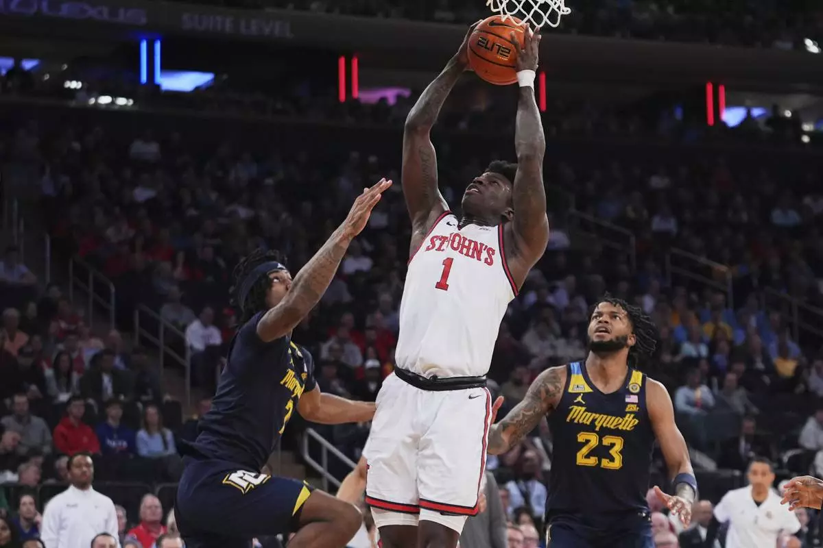 St. John's's Kadary Richmond (1) shoots over Marquette's Chase Ross (2) and David Joplin (23) during the first half of an NCAA college basketball game in the semifinals of the Big East tournament Friday, March 14, 2025, in New York. (AP Photo/Frank Franklin II)