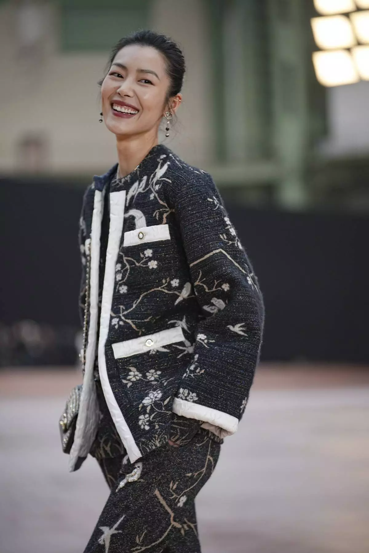 Liu Wen arrives for the the Chanel Fall/Winter 2025-2026 Womenswear collection presented Tuesday, March 11, 2025. in Paris. (AP Photo/Christophe Ena).