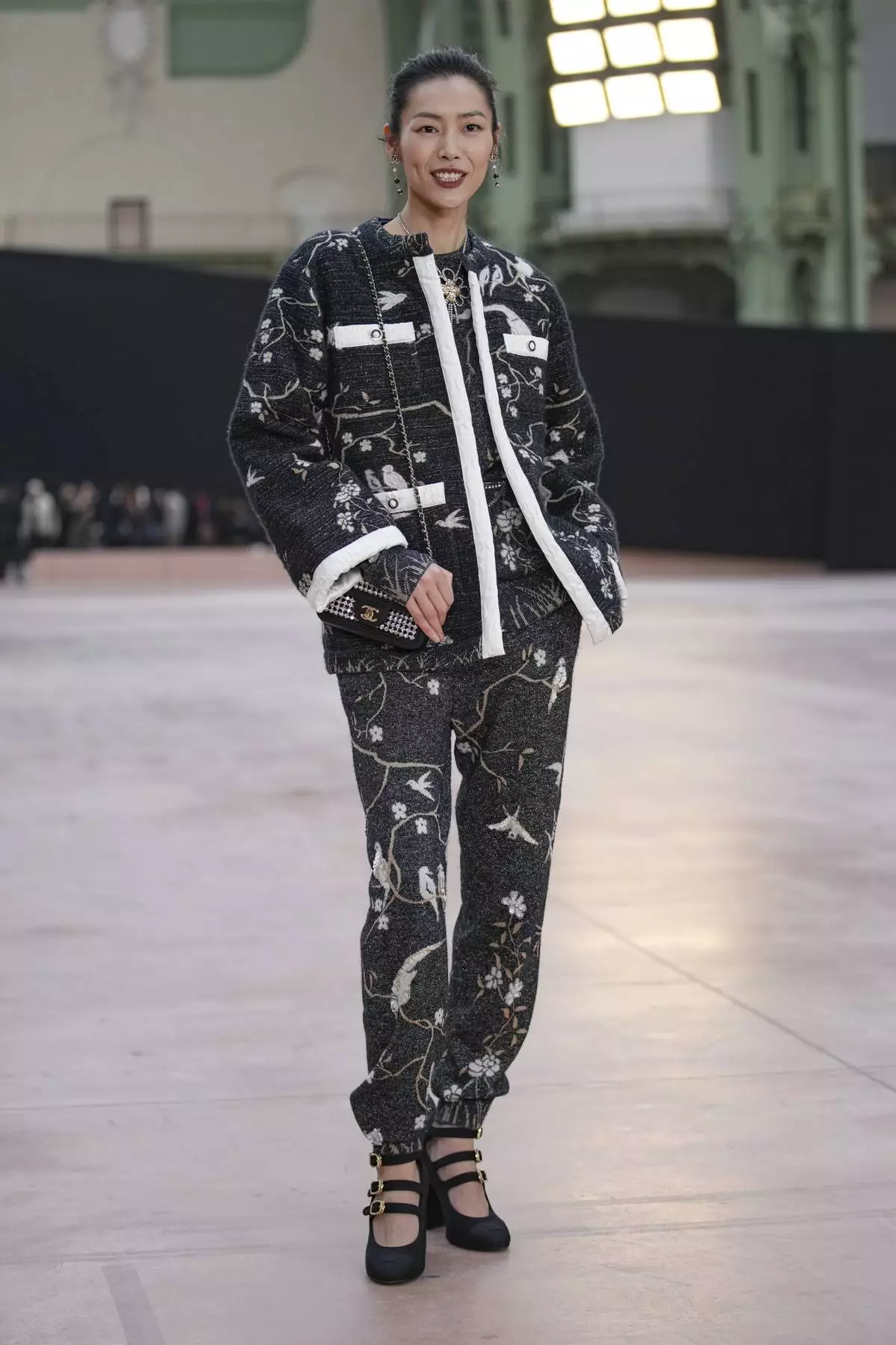 Liu Wen arrives for the the Chanel Fall/Winter 2025-2026 Womenswear collection presented Tuesday, March 11, 2025. in Paris. (AP Photo/Christophe Ena).