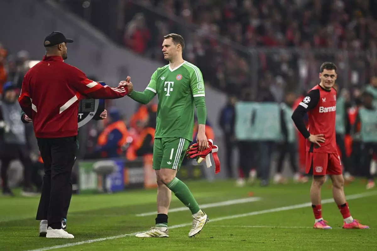 Munich's goalkeeper Manuel Neuer, center, walks off the pitch during the Champions League round of 16 first leg soccer match between FC Bayern Munich and Bayer 04 Leverkusen in Munich, Germany, Wednesday, March 5, 2025. (Tom Weller/dpa via AP)