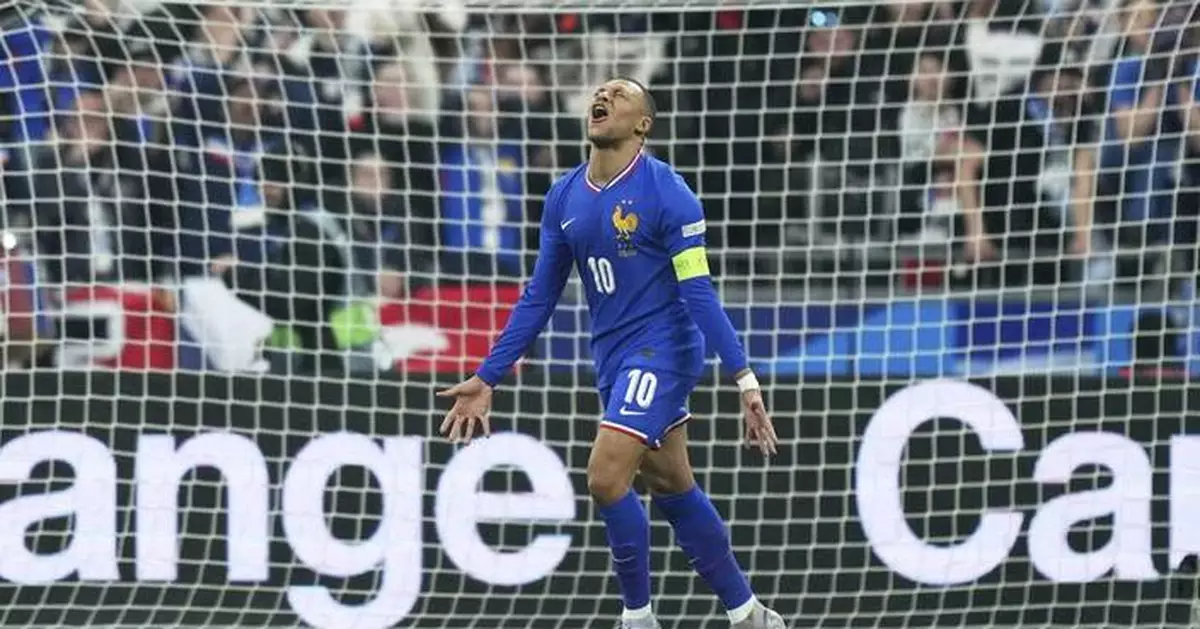 Mbappé looks impressed when he meets his waxwork statue at Madame Tussauds