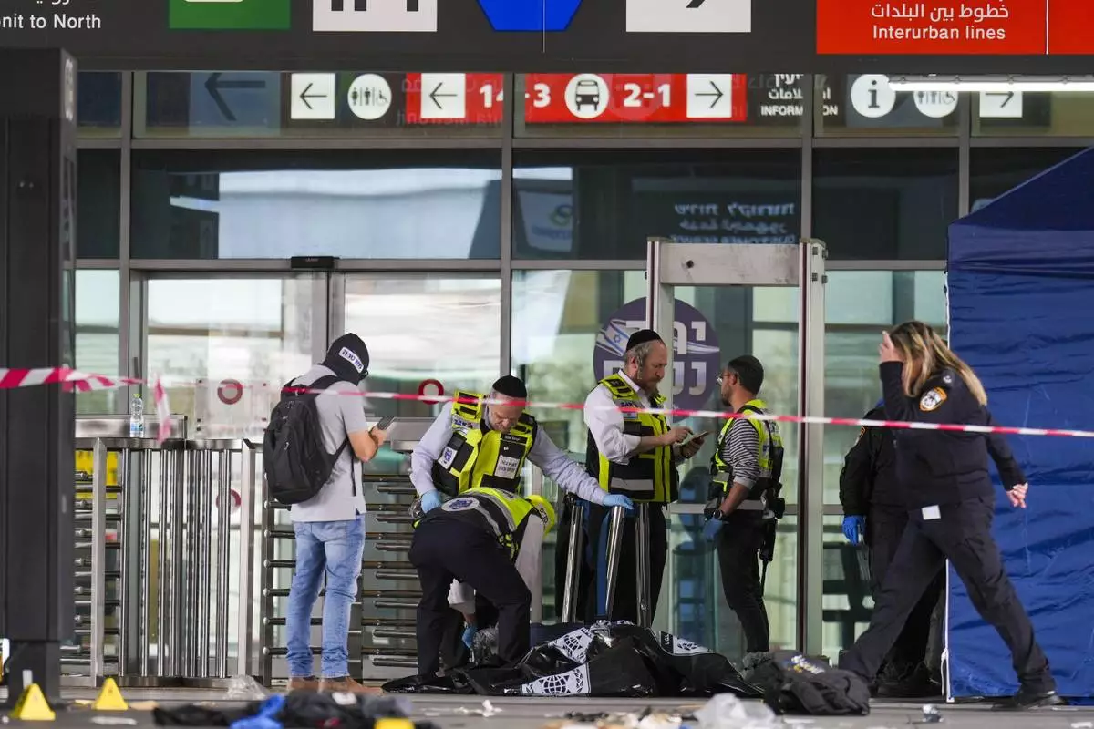 Israeli rescue and security forces examine the scene of a stabbing attack in Haifa, Israel, on Monday, March 30, 2025, where a 70-year-old man was killed and four others were injured. (AP Photo/Ariel Schalit)