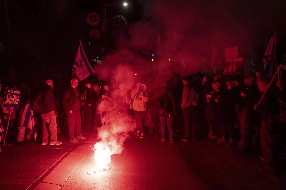 Israelis take part in a protest against Israeli Prime Minister Benjamin Netanyahu's government, and the release of the hostages held in the Gaza Strip by the Hamas militant group, in Jerusalem, Sunday, March 2, 2025. (AP Photo/Ohad Zwigenberg)