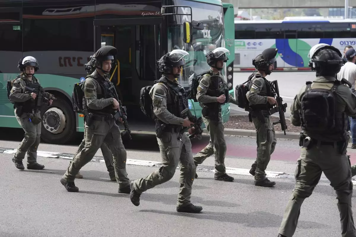 Israeli security forces secure the scene of a stabbing attack in Haifa, Israel, on Monday, March 30, 2025, where a 70-year-old man was killed and four others were injured. (AP Photo/Ariel Schalit)