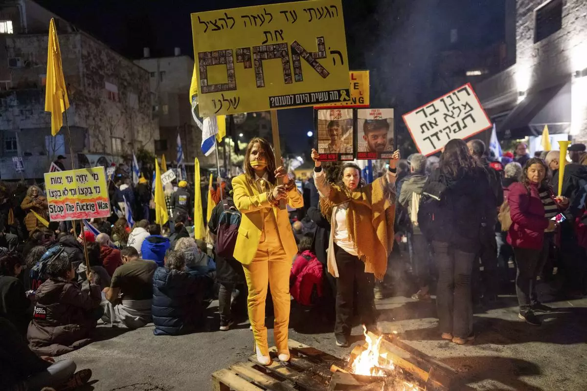 Israelis take part in a protest against Israeli Prime Minister Benjamin Netanyahu's government, and the release of the hostages held in the Gaza Strip by the Hamas militant group, in Jerusalem,Sunday, March 2, 2025. (AP Photo/Ohad Zwigenberg)