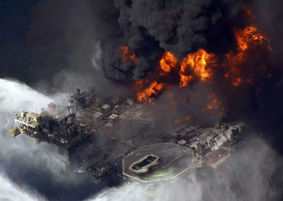 FILE - A plume of smoke rises from fires on BP's Deepwater Horizon offshore oil rig in the Gulf of Mexico on April 21, 2010. (AP Photo/Gerald Herbert, File)