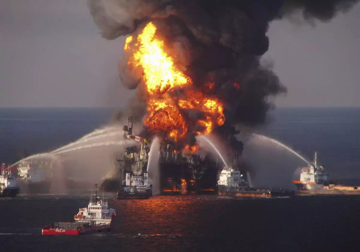 FILE - In this April 21, 2010 file photo provided by the U.S. Coast Guard, fire boat response crews spray water on the burning BP Deepwater Horizon offshore oil rig. (U.S. Coast Guard via AP, File)