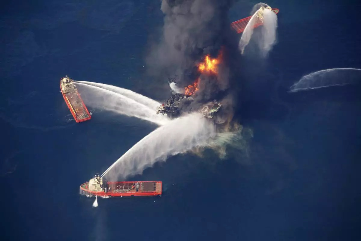 FILE - The Deepwater Horizon oil rig burns in the Gulf of Mexico on April 21, 2010, following an explosion that killed 11 workers and caused the worst offshore oil spill in the nation's history. (AP Photo/Gerald Herbert, File)
