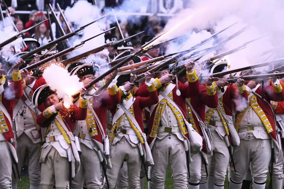 British Regulars fire on New England colonial militia, also known as a Minutemen, during a reenactment celebration of the 250th anniversary of the Battle of Lexington and start of the American Revolution, Saturday, April 19, 2025, in Lexington, Mass. (AP Photo/Charles Krupa)