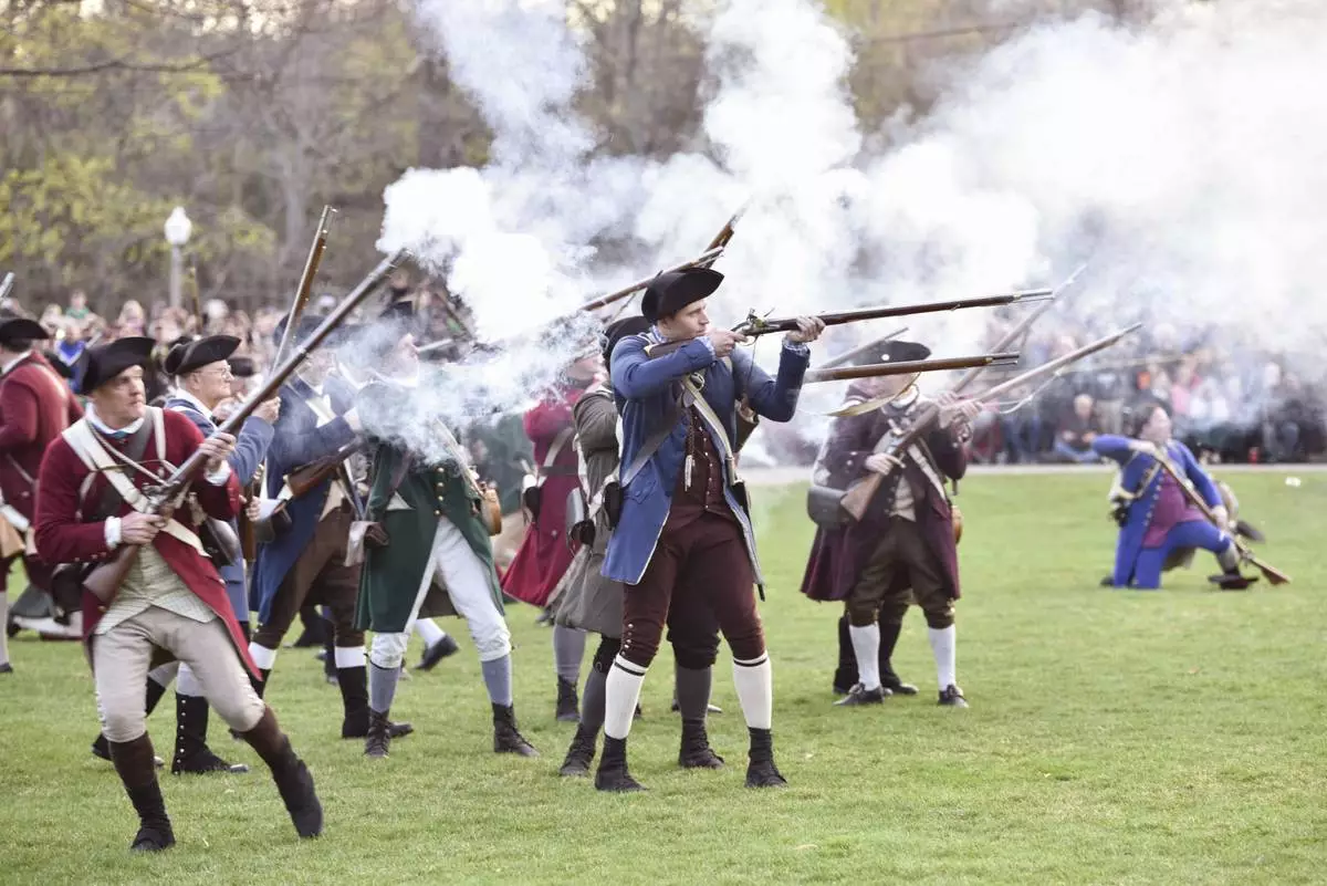 FILE - Colonial soldiers fire on the British during the Patriots' Day reenactment of the battles of Lexington and Concord, in Lexington, Mass. Monday, Aril 17, 2017. (Keith Viglione/The Boston Herald via AP,File)