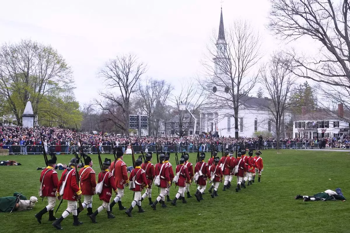 British Regulars march past fallen New England colonial militia, also known as a Minuteman, during a reenactment celebration of the 250th anniversary of the Battle of Lexington and start of the American Revolution, Saturday, April 19, 2025, in Lexington, Mass. (AP Photo/Charles Krupa)