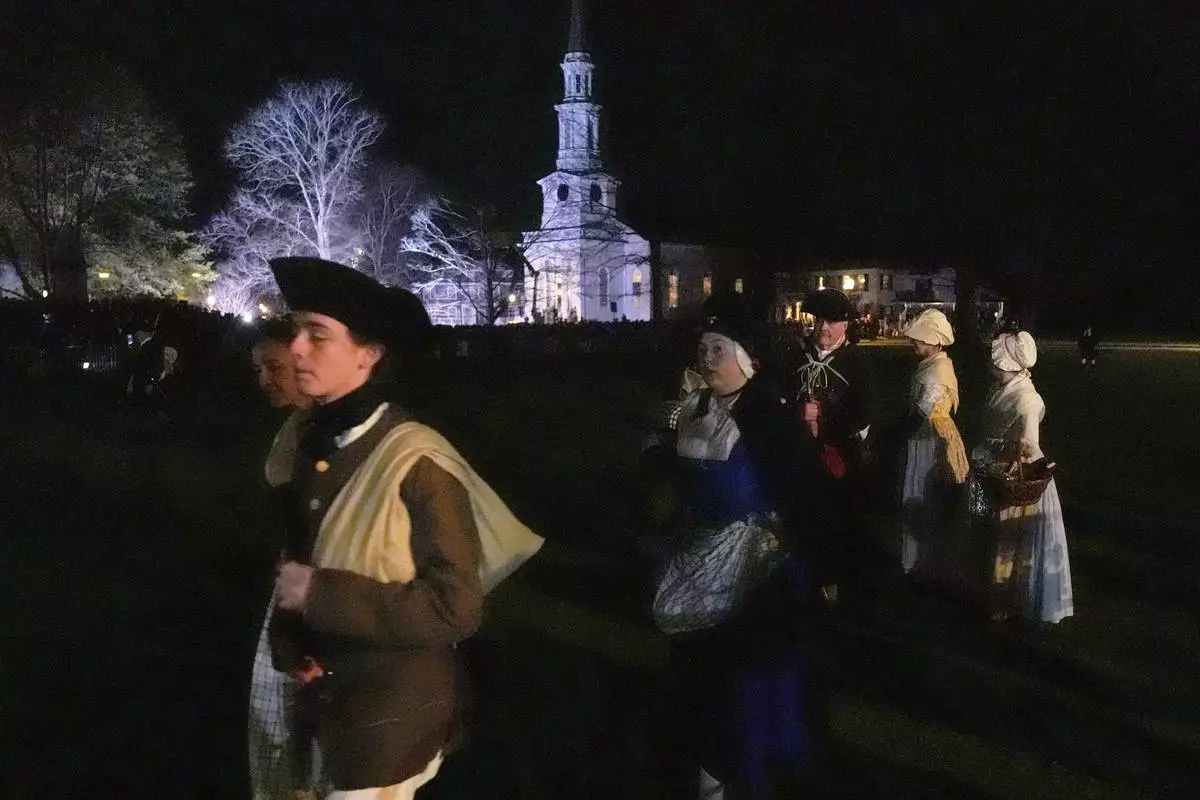Colonials gather prior to facing the British Regulars during a reenactment celebration of the 250th anniversary of the Battle of Lexington and start of the American Revolution, Saturday, April 19, 2025, in Lexington, Mass. (AP Photo/Charles Krupa)