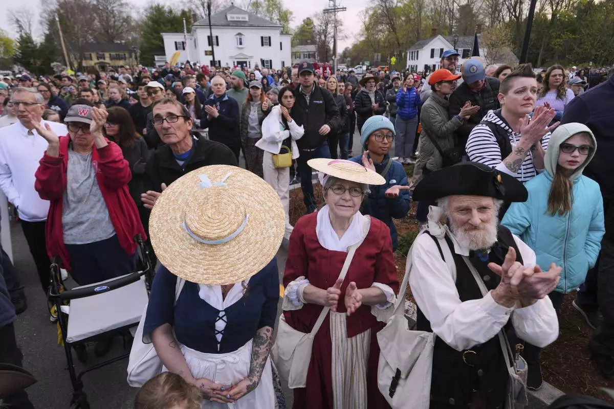 Thousands, some dressed in period clothing, watch a reenactment celebration of the 250th anniversary of the Battle of Lexington and start of the American Revolution, Saturday, April 19, 2025, in Lexington, Mass. (AP Photo/Charles Krupa)