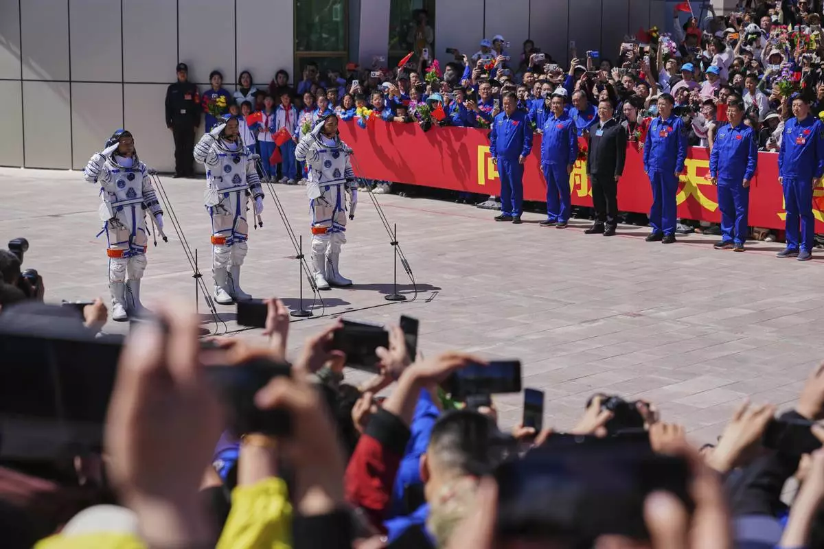 Chinese astronauts for the Shenzhou 20 mission, from right, Chen Zhongrui, Chen Dong and Wang Jie salute as they attend a send-off ceremony for their manned space mission at the Jiuquan Satellite Launch Center in northwestern China, Thursday, April 24, 2025. (AP Photo/Andy Wong)