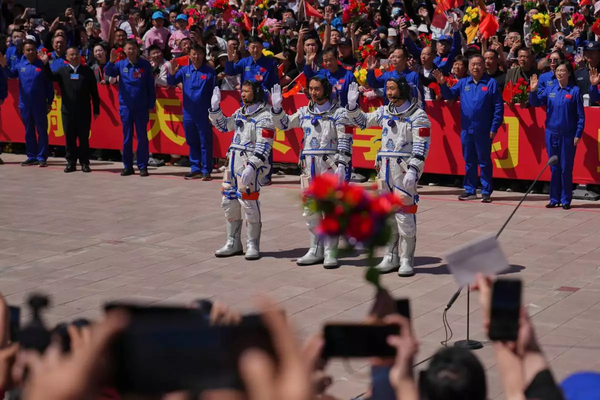 Chinese astronauts for the Shenzhou 20 mission, from right, Chen Zhongrui, Chen Dong and Wang Jie wave as they attend a send-off ceremony for their manned space mission at the Jiuquan Satellite Launch Center in northwestern China, Thursday, April 24, 2025. (AP Photo/Andy Wong)