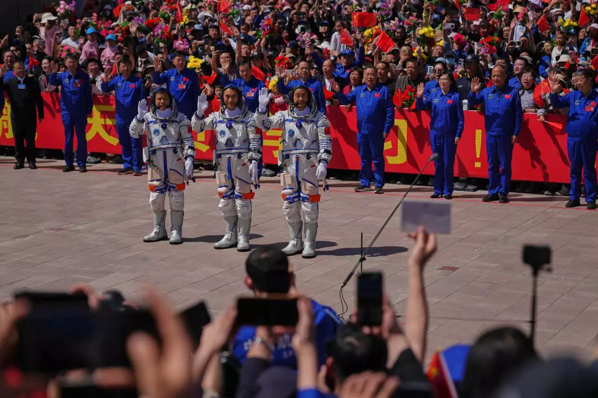 Chinese astronauts for the Shenzhou 20 mission, from right, Chen Zhongrui, Chen Dong and Wang Jie wave as they attend a send-off ceremony for their manned space mission at the Jiuquan Satellite Launch Center in northwestern China, Thursday, April 24, 2025. (AP Photo/Andy Wong)