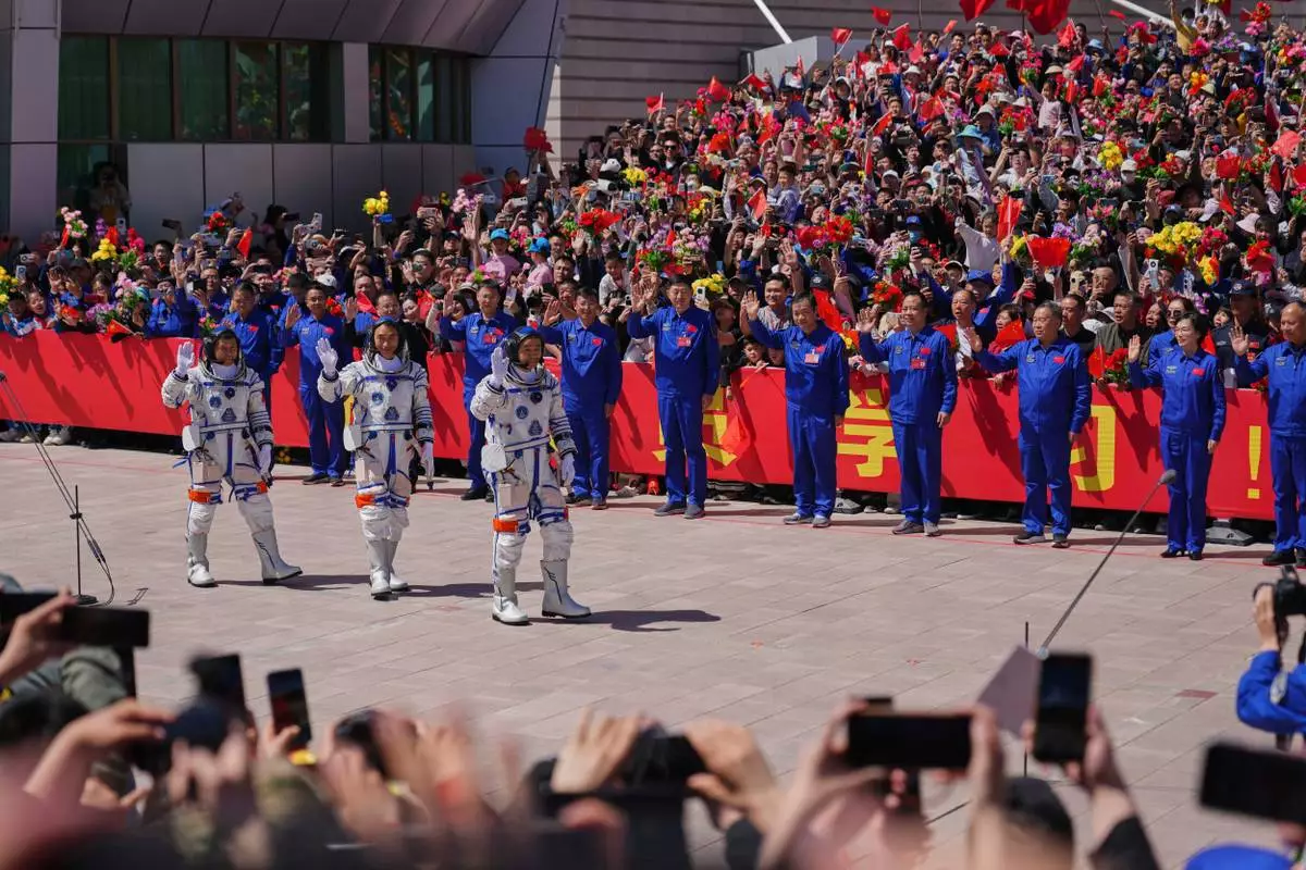 Chinese astronauts for the Shenzhou 20 mission, from right, Chen Zhongrui, Chen Dong and Wang Jie wave as they attend a send-off ceremony for their manned space mission at the Jiuquan Satellite Launch Center in northwestern China, Thursday, April 24, 2025. (AP Photo/Andy Wong)
