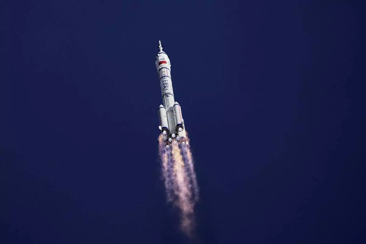 China's Long March 2F rocket, carrying three astronauts for the Shenzhou 20 manned space mission, heads for a space station, at the Jiuquan Satellite Launch Center in Jiuquan, northwestern China, Thursday, April 24, 2025. (AP Photo/Andy Wong)