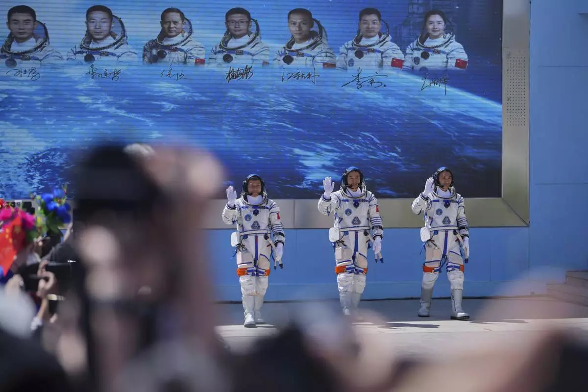 Chinese astronauts for the Shenzhou 20 mission, from right, Chen Zhongrui, Chen Dong and Wang Jie wave as they attend a send-off ceremony for their manned space mission at the Jiuquan Satellite Launch Center in northwestern China, Thursday, April 24, 2025. (AP Photo/Andy Wong)