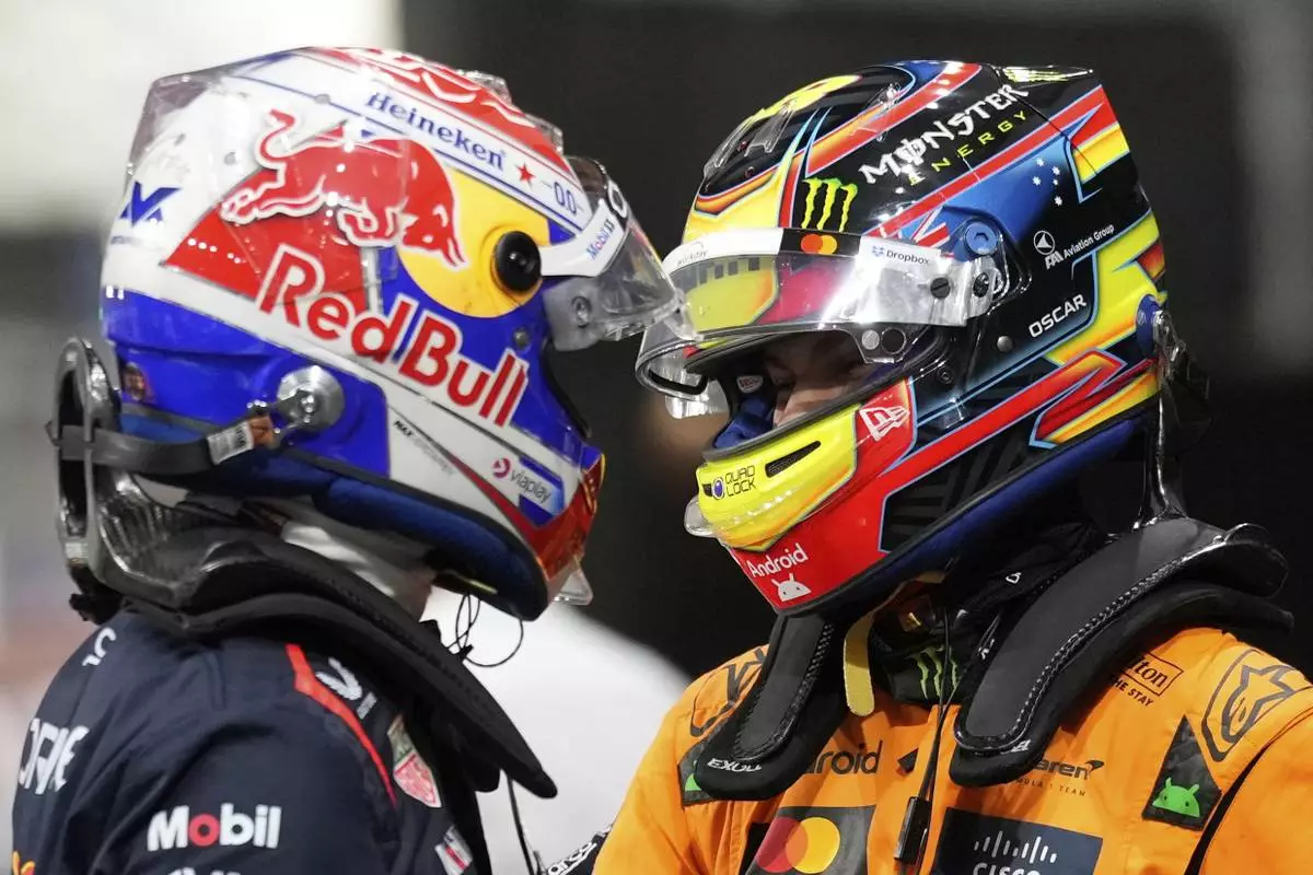 Red Bull driver Max Verstappen of the Netherlands, pole position, left, cheers with McLaren driver Oscar Piastri of Australia, second fastest time, after the qualifying session ahead of the Formula One Saudi Arabian Grand Prix at the Jeddah Corniche Circuit in Jeddah, Saudi Arabia, Saturday, April 19, 2025. (AP Photo/Darko Bandic)