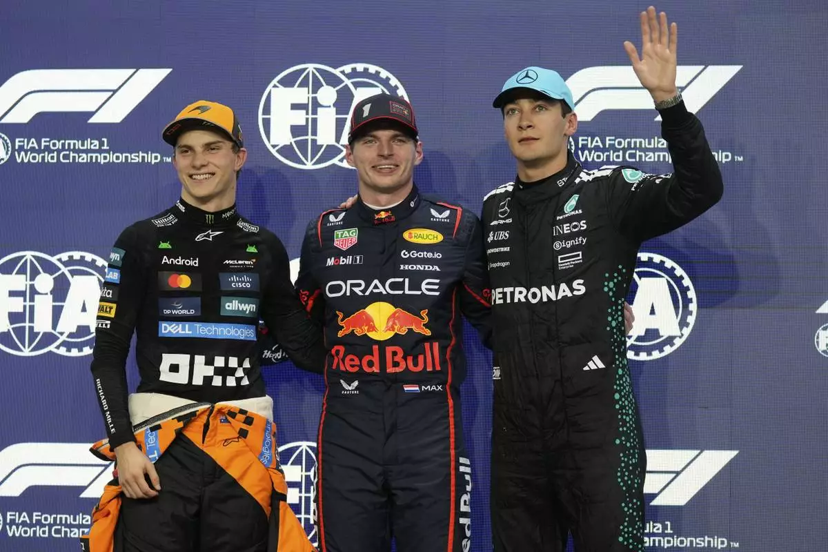 Red Bull driver Max Verstappen of the Netherlands, center, pole position, is flanked by McLaren driver Oscar Piastri of Australia, left, second fastest time and Mercedes driver George Russell of Britain, third fastest time after the qualifying session ahead of the Formula One Saudi Arabian Grand Prix at the Jeddah Corniche Circuit in Jeddah, Saudi Arabia, Saturday, April 19, 2025. (AP Photo/Darko Bandic)