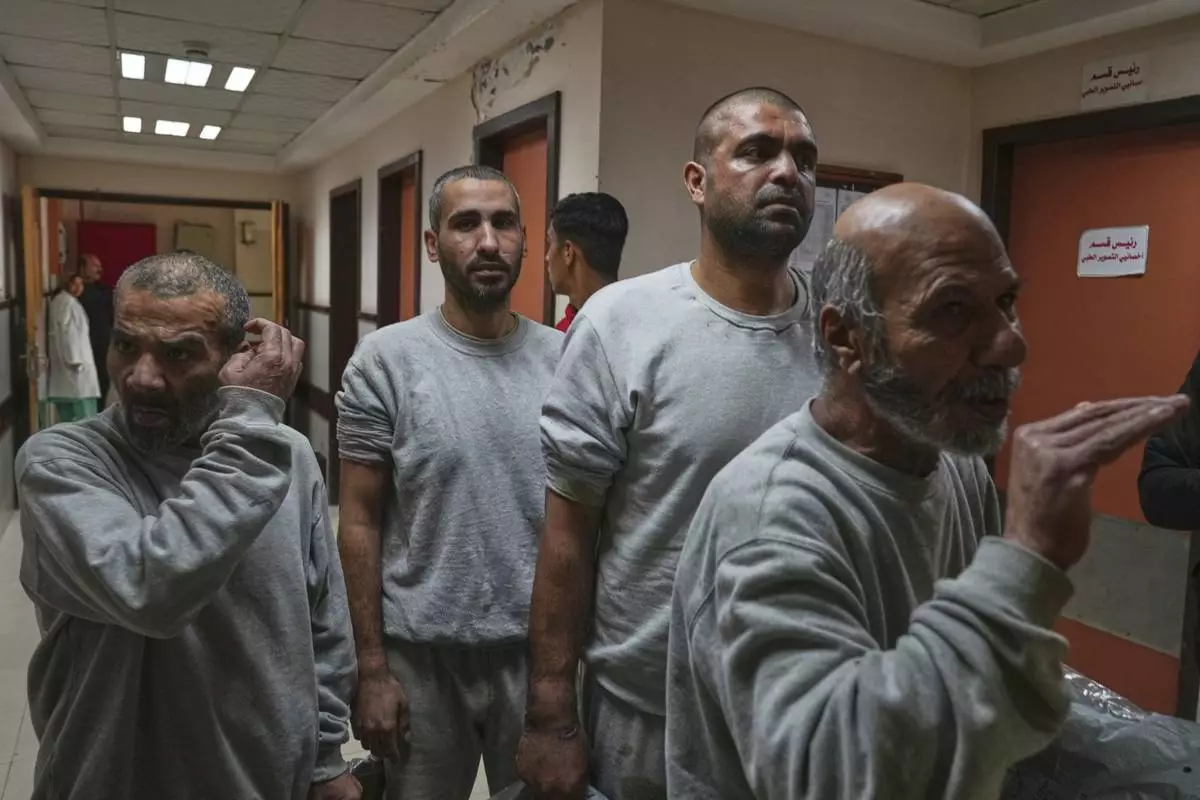 Freed Palestinian prisoners upon arrival at al-Aqsa Hospital in Deir al-Balah, central Gaza Strip, after being released from an Israeli prison, Thursday, April 10, 2025. (AP Photo/Abdel Kareem Hana)