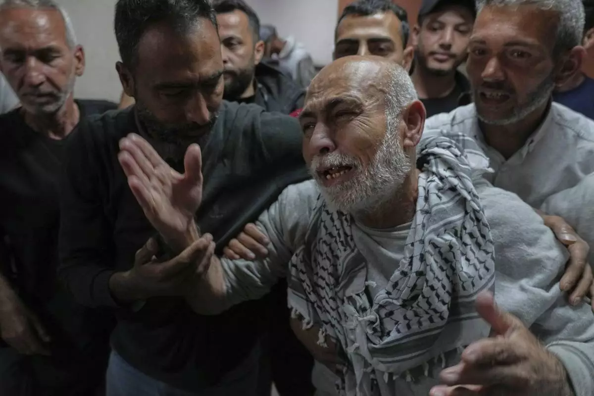 Freed Palestinian prisoner Naeim Al Burai, 66, is welcomed upon arrival at al-Aqsa Hospital in Deir al-Balah, central Gaza Strip, after being released from an Israeli prison, Thursday, April 10, 2025. (AP Photo/Abdel Kareem Hana)