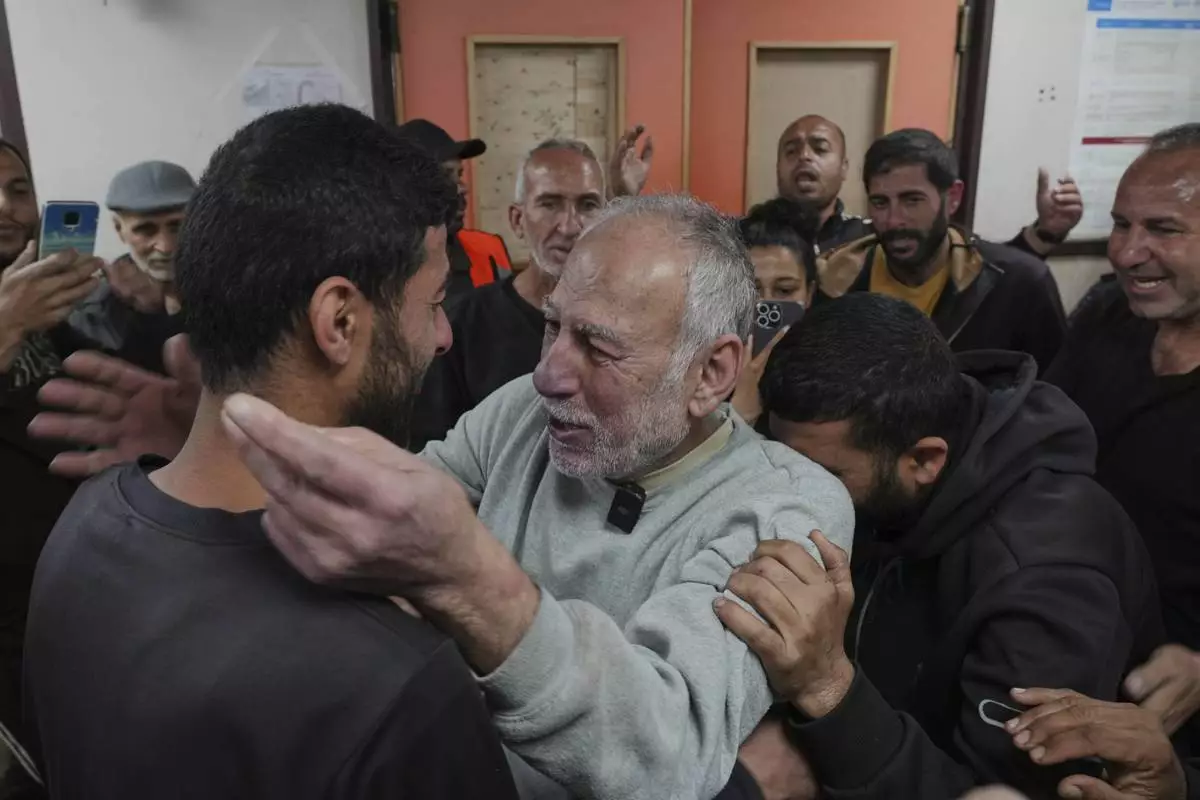 Freed Palestinian prisoner Jamal Zuweiri, 69, center, is welcomed upon arrival at al-Aqsa Hospital in Deir al-Balah, central Gaza Strip, after being released from an Israeli prison, Thursday, April 10, 2025. (AP Photo/Abdel Kareem Hana)