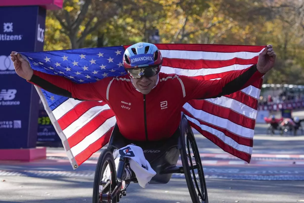 FILE - Daniel Romanchuk poses for photos after winning the men's wheelchair division of the New York City Marathon, Nov. 3, 2024, in New York. (AP Photo/Frank Franklin II, File)