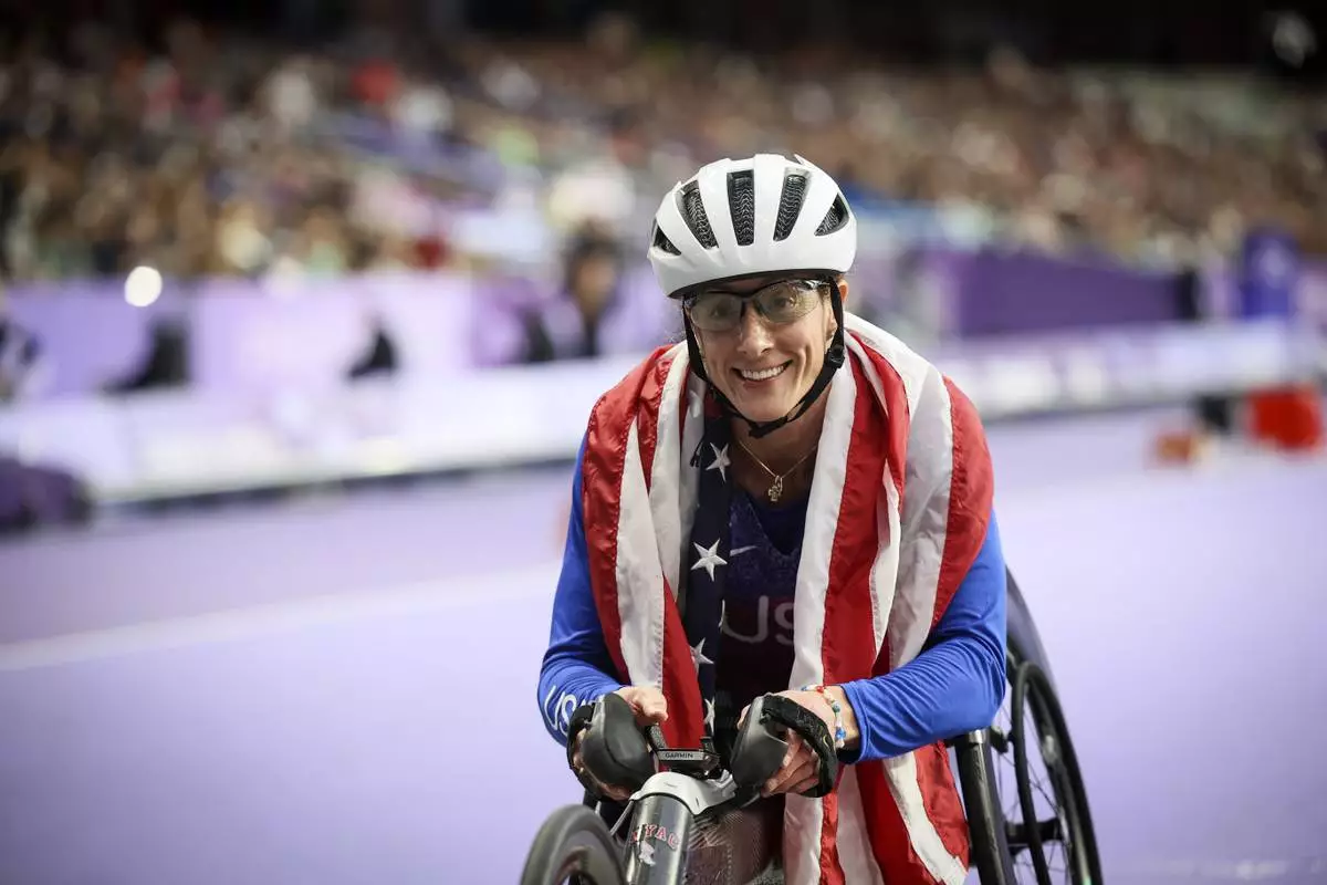 FILE - Tatyana McFadden of the U.S., celebrates before being informed she has been disqualified of the women's 400 m. T54 at the 2024 Paralympics, Sept. 5, 2024, in Paris. (AP Photo/Thomas Padilla, File)