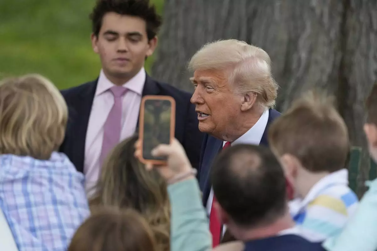 President Donald Trump greets people during the White House Easter Egg Roll on the South Lawn of the White House, Monday, April 21, 2025, in Washington. (AP Photo/Alex Brandon)