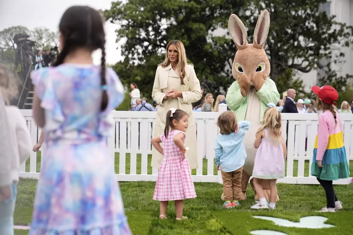 First lady Melania Trump talks with children as they play a game of hopscotch during the White House Easter Egg Roll on the South Lawn of the White House, Monday, April 21, 2025, in Washington. (AP Photo/Mark Schiefelbein)