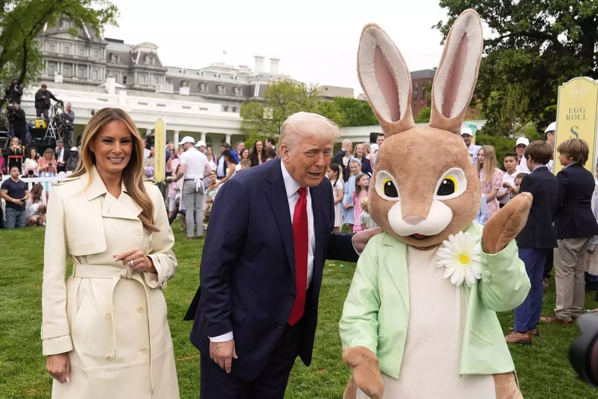President Donald Trump and first lady Melania Trump, stand with the Easter bunny as they participate in the White House Easter Egg Roll on the South Lawn of the White House, Monday, April 21, 2025, in Washington. (AP Photo/Mark Schiefelbein)