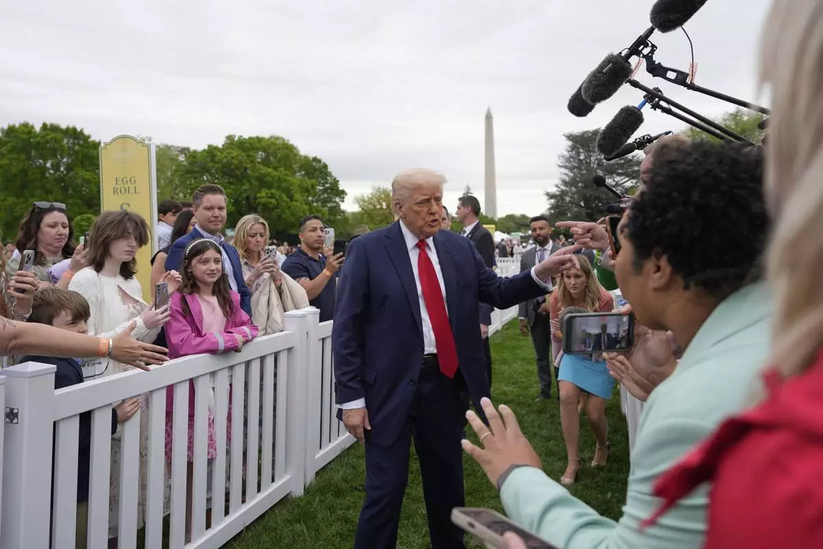 President Donald Trump greets people during the White House Easter Egg Roll on the South Lawn of the White House, Monday, April 21, 2025, in Washington. (AP Photo/Alex Brandon)