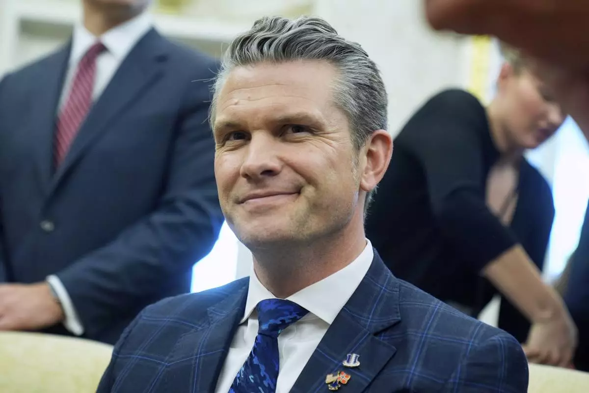 Secretary of Defense Pete Hegseth listens as President Donald Trump meets with Norwegian Prime Minister Jonas Gahr Støre during a bilateral meeting in the Oval Office of the White House, Thursday, April 24, 2025, in Washington. (AP Photo/Mark Schiefelbein)