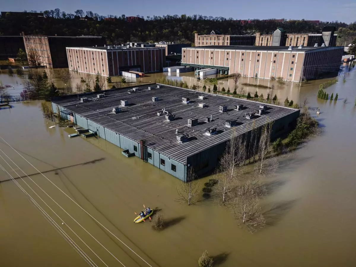 FILE - Kayakers paddle on the floodwaters at the Buffalo Trace Distillery on Monday, April 7, 2025, in Frankfort, Ky. (AP Photo/Jon Cherry, File)