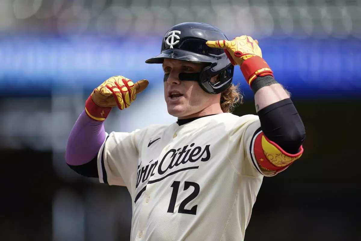 Minnesota Twins' Harrison Bader (12) gestures after hitting a single during the third inning of a baseball game against the New York Mets, Wednesday, April 16, 2025, in Minneapolis. (AP Photo/Abbie Parr)
