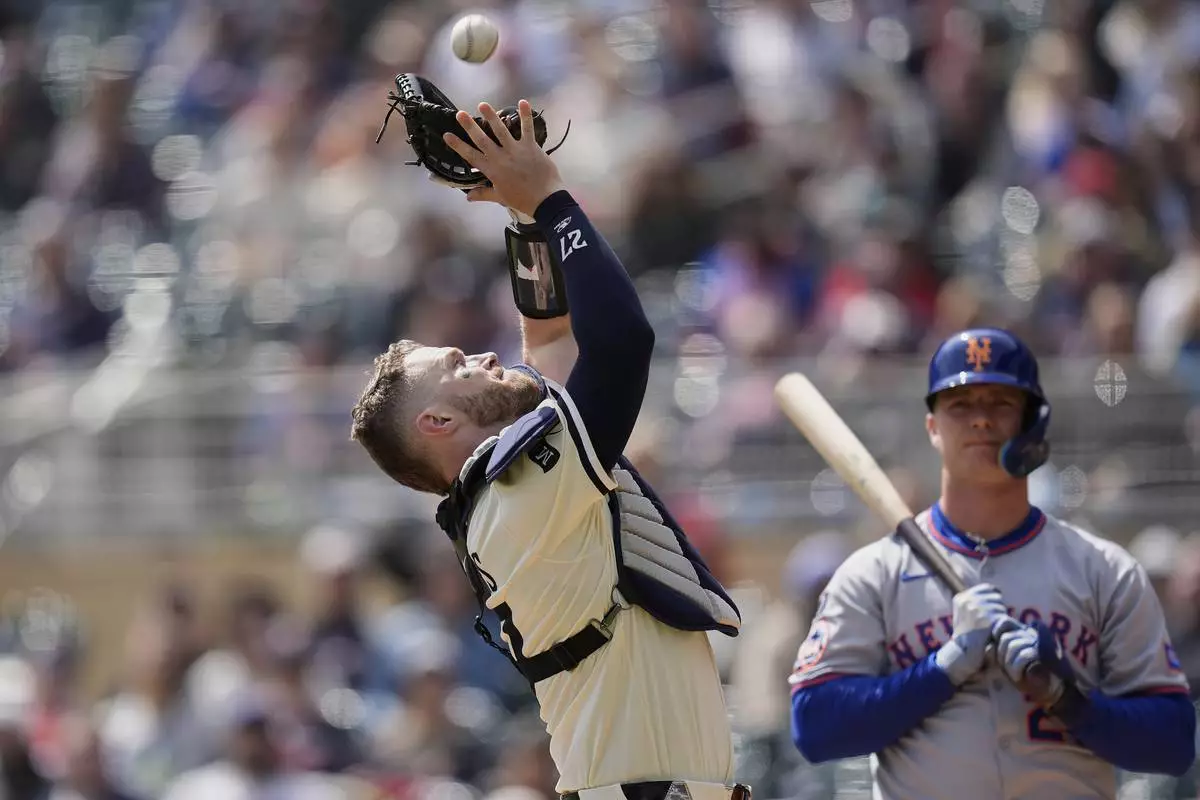Minnesota Twins catcher Ryan Jeffers (27) catches a foul out hit by New York Mets' Pete Alonso, right, during the first inning of a baseball game Wednesday, April 16, 2025, in Minneapolis. (AP Photo/Abbie Parr)