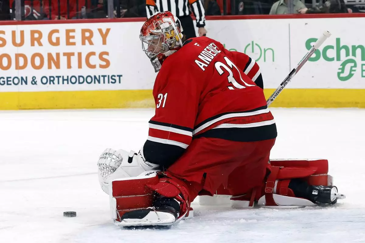 Carolina Hurricanes goaltender Frederik Andersen (31) blocks a shot from the Toronto Maple Leafs during the first period of an NHL hockey game in Raleigh, N.C., Sunday, April 13, 2025. (AP Photo/Karl DeBlaker)