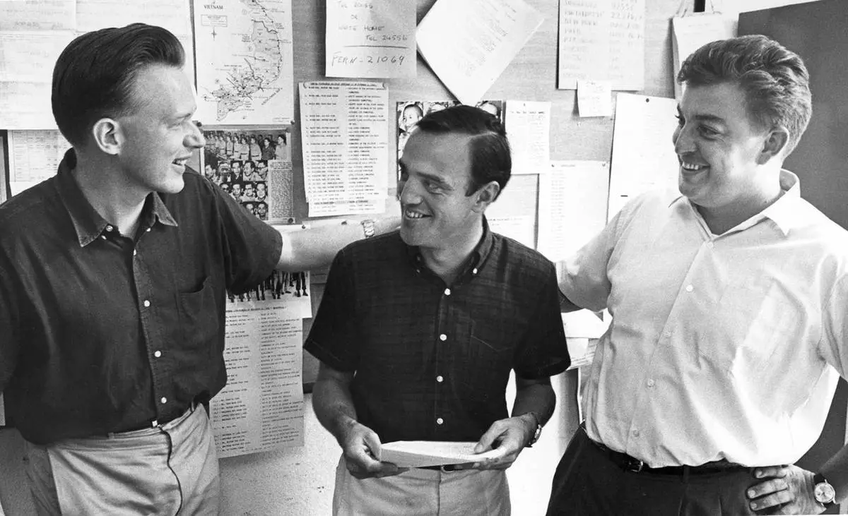 Upon learning that he has won the 1966 Pulitzer Prize for International Reporting, AP reporter Peter Arnett, center, accepts congratulations at the Saigon bureau from fellow Pulitzer winners Malcolm Browne, left, and Horst Faas. Browne shared the 1964 Pulitzer for International Reporting, and Faas won the 1965 Pulitzer for Photography. AP's Saigon bureau would eventually win five Pulitzers during the war. (AP Photo)