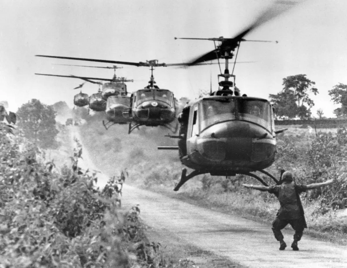 FILE- Huey helicopters, carrying troops of the U.S. 173rd Airborne Brigade, settle in for a landing near the Montagnard village of Plei Ho Drong in August 1965. The unit found friendly mountain tribal people, but no Viet Cong. (AP Photo/Horst Faas, File)