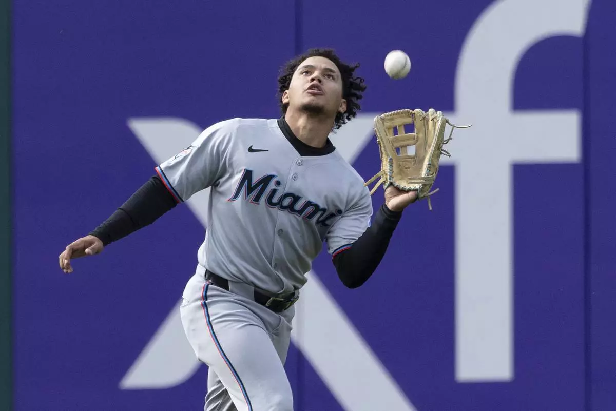 Miami Marlins left fielder Javier Sanoja (46) catches a fly from Philadelphia Phillies' Alec Bohm in the 10th inning of a baseball game, Sunday, April 20, 2025, in Philadelphia. (AP Photo/Laurence Kesterson)