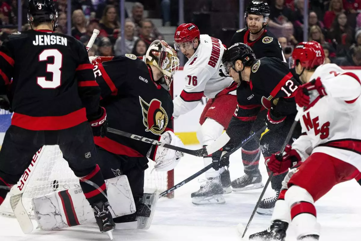 Carolina Hurricanes center Skyler Brind'Amour (76) scores against Ottawa Senators goaltender Linus Ullmark, second from left, during first-period NHL hockey game action in Ottawa, Ontario, Thursday, April 17, 2025. (Spencer Colby/The Canadian Press via AP)