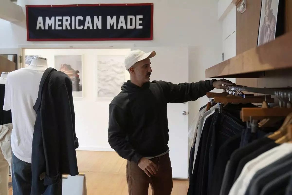 Javid Moghaddasnia, Director of Customer Engagement, discusses American Giant clothing while being interviewed at the company's showroom in San Francisco, Thursday, April 17, 2025. (AP Photo/Jeff Chiu)