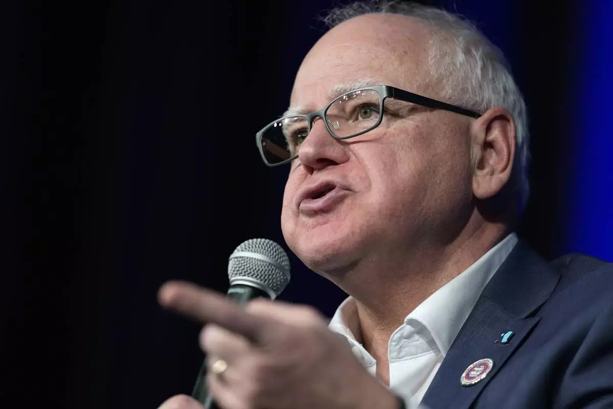 FILE - Minnesota Gov. Tim Walz speaks at a town hall event at Roosevelt High School, Friday, March 14, 2025, in Des Moines, Iowa. (AP Photo/Matthew Putney,File)