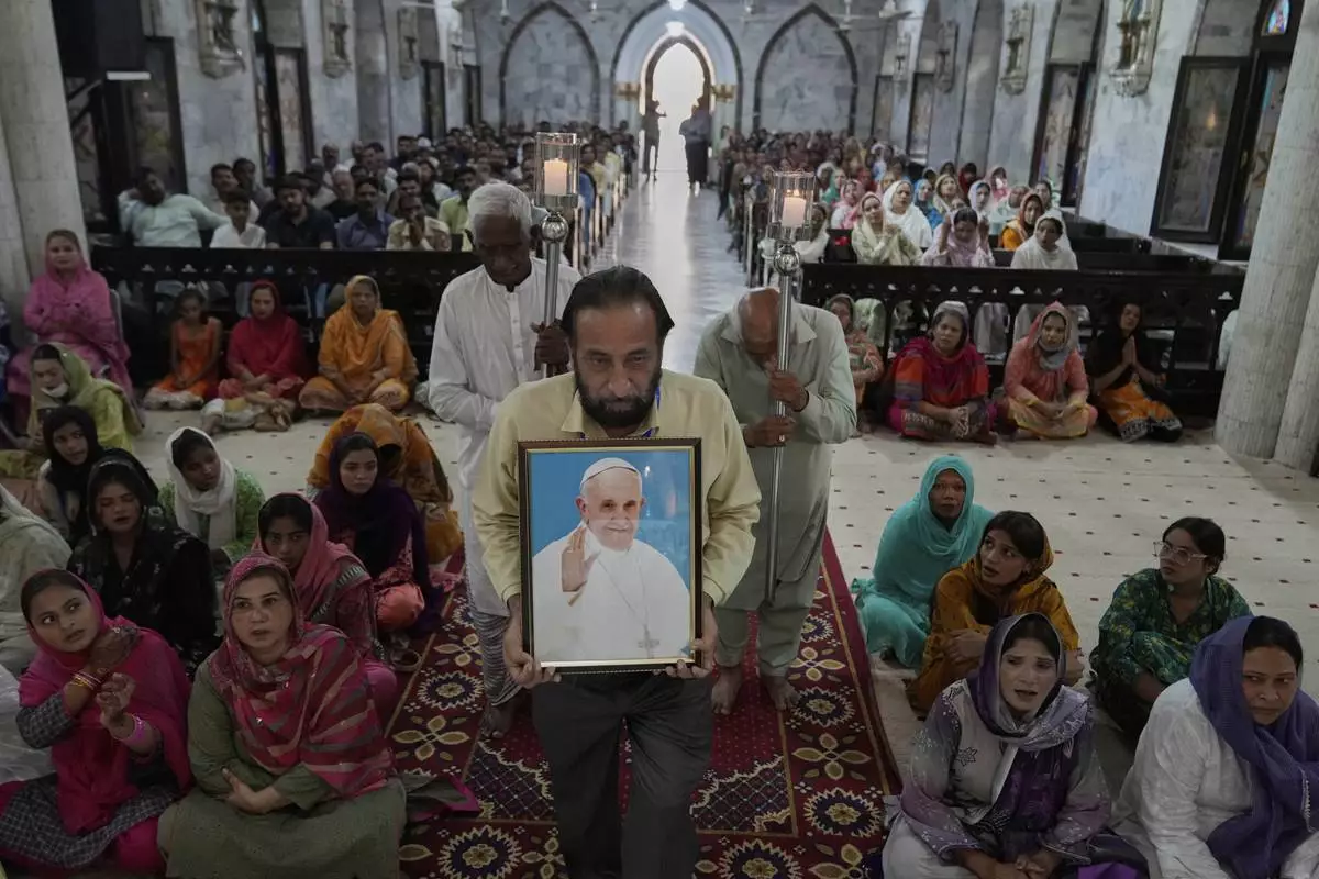 Christians attend prayer services for the late Pope Francis at St. Anthony Church in Lahore, Pakistan, Tuesday, April 22, 2025. (AP Photo/K.M. Chaudary)