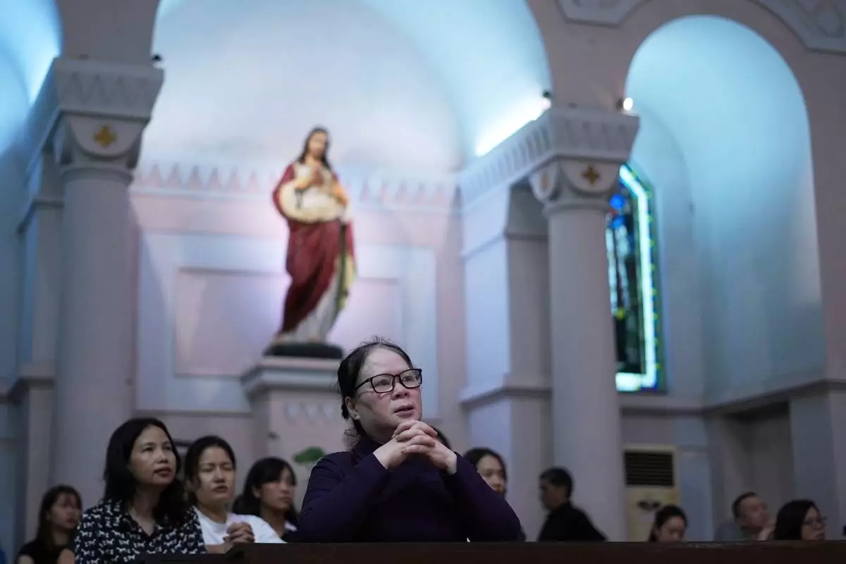 Faithful pray during a mass honoring Pope Francis at the Cua Bac Parish Church in Hanoi, Vietnam on April 23, 2025. (AP Photo/Hau Dinh)
