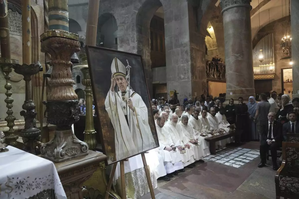 Clergy take part in a Mass led by Latin Patriarch Pierbattista Pizzaballa, the top Catholic clergyman in the Holy Land, in remembrance of Pope Francis at the Church of the Holy Sepulcher, the site where according to tradition Jesus was crucified and buried, in the Old City of Jerusalem, Wednesday, April 23, 2025. (AP Photo/Mahmoud Illean)